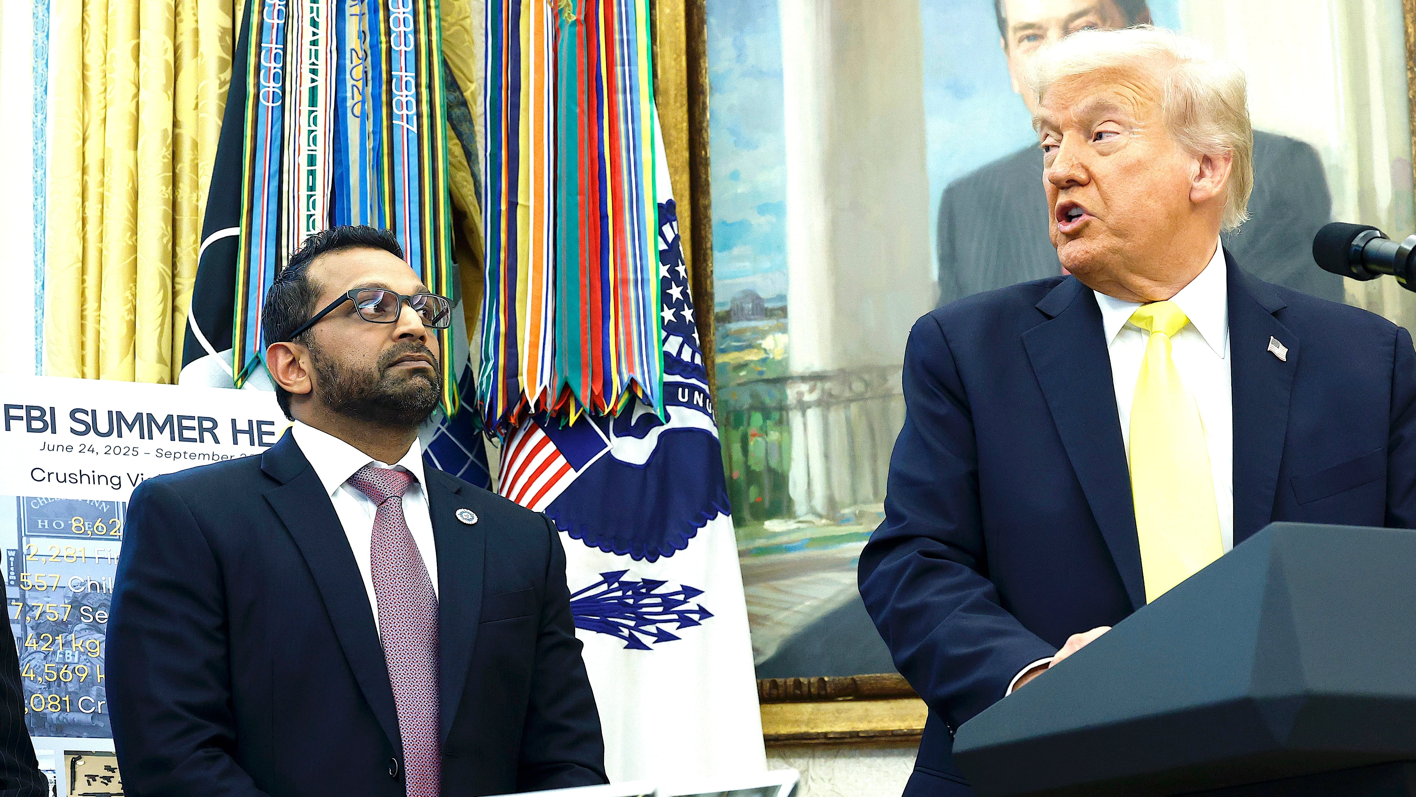 President Donald Trump speaking with FBI Director Kash Patel.