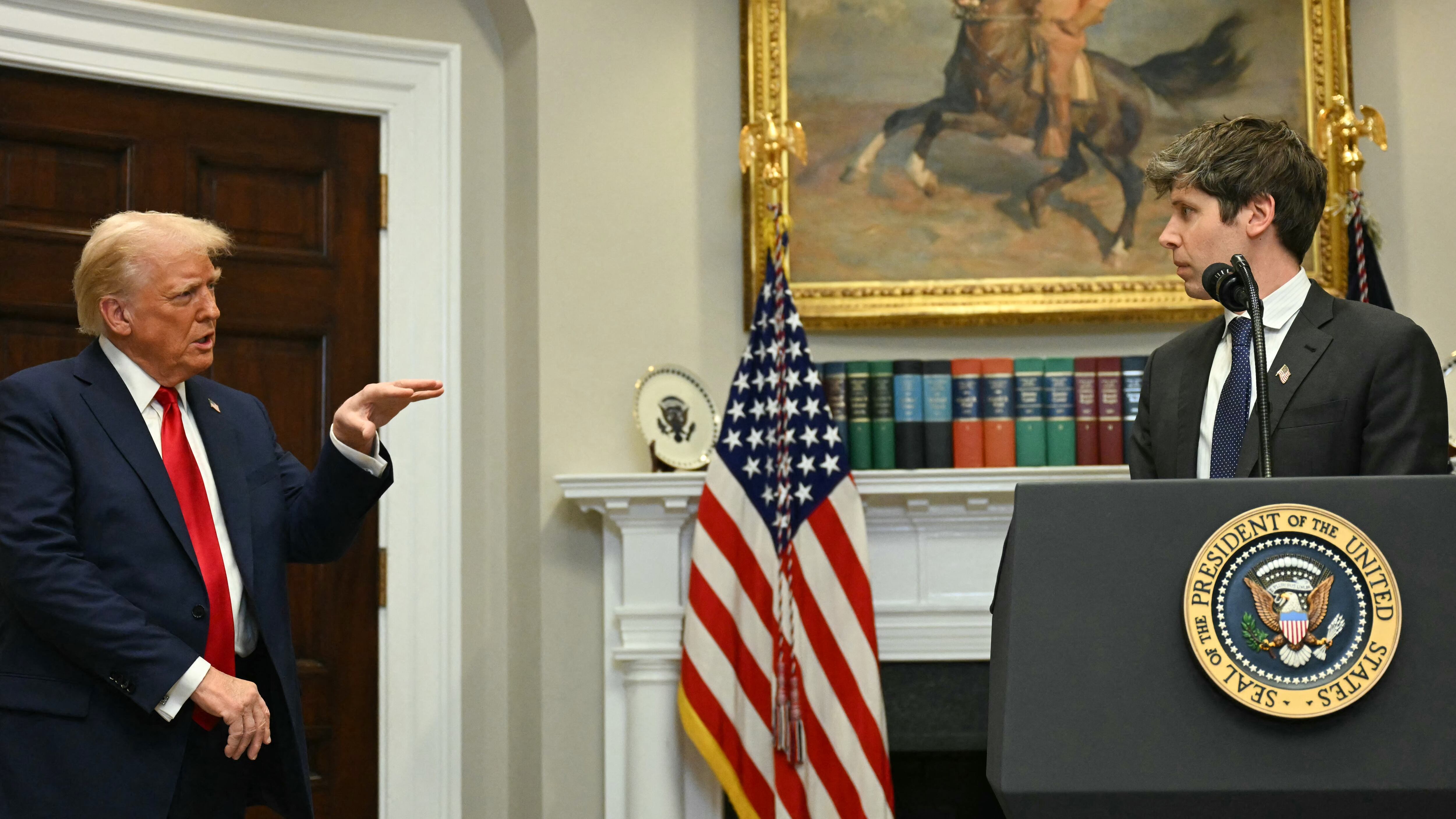 US President Trump gestures as CEO of Open AI Sam Altman speaks in the Roosevelt Room at the White House.