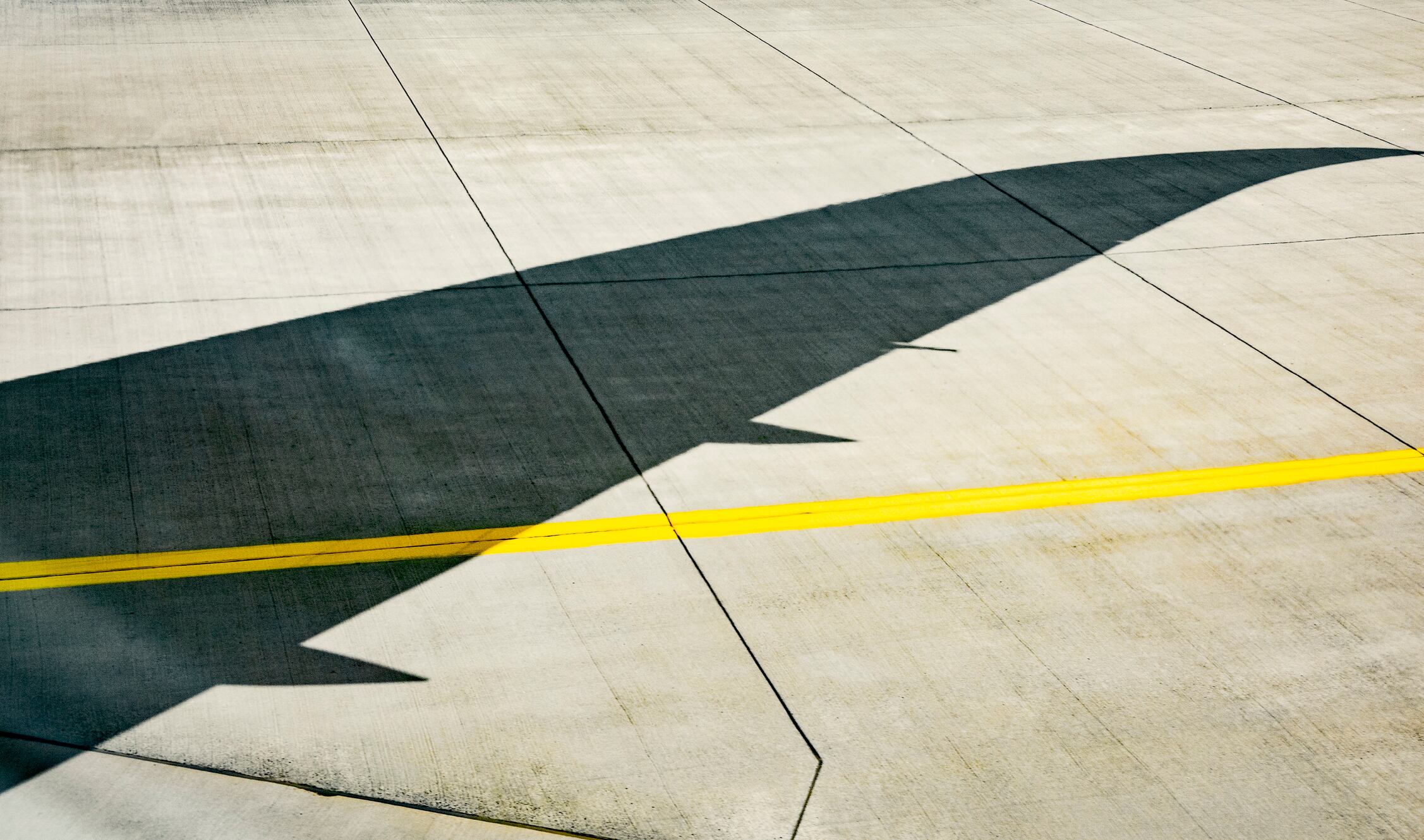 Shadow of an airplane wing on the runway.