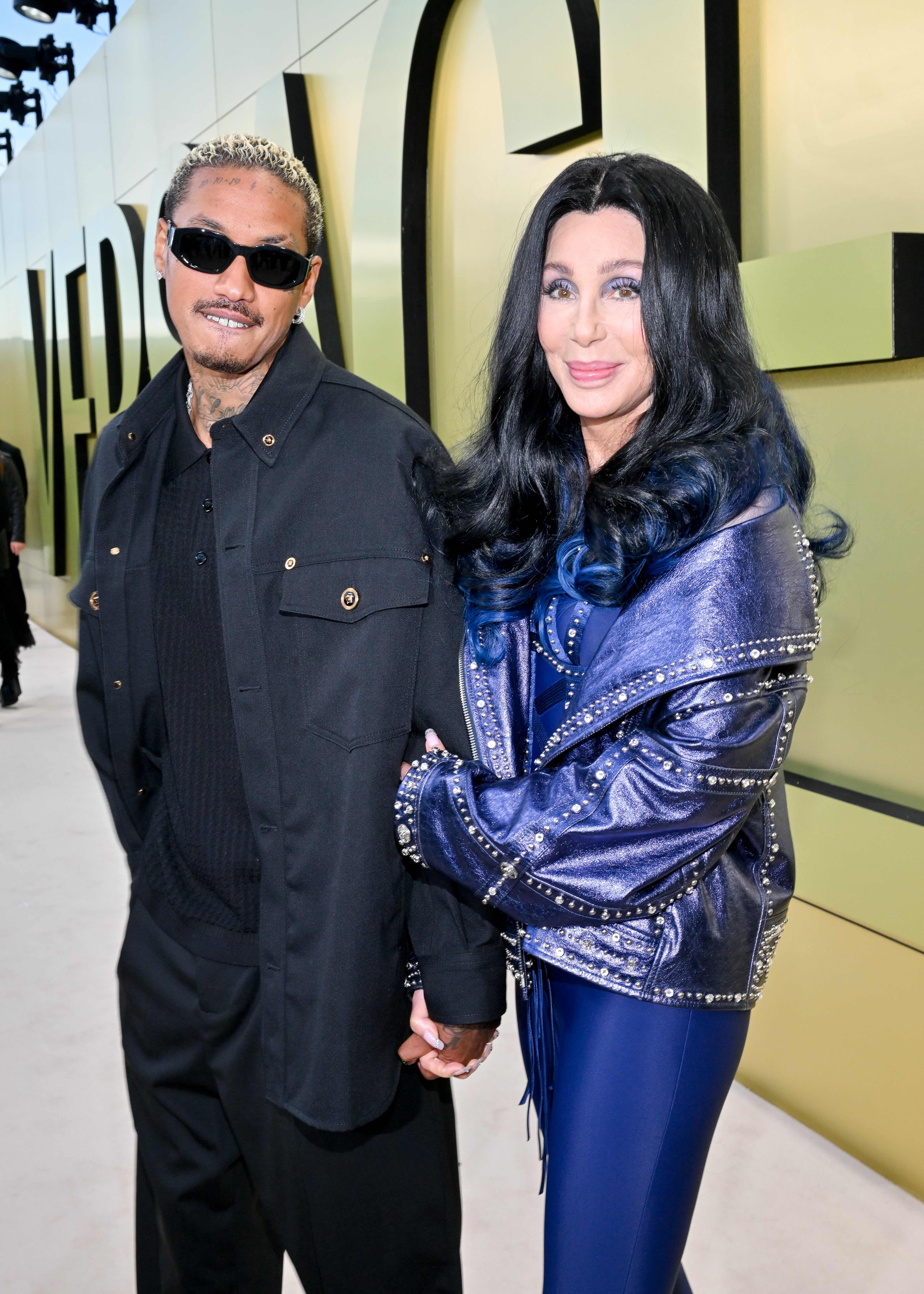 Alexander Edwards and Cher at the Versace Fall-Winter 2023 Fashion Show. / Michael Buckner/Variety via Getty Images