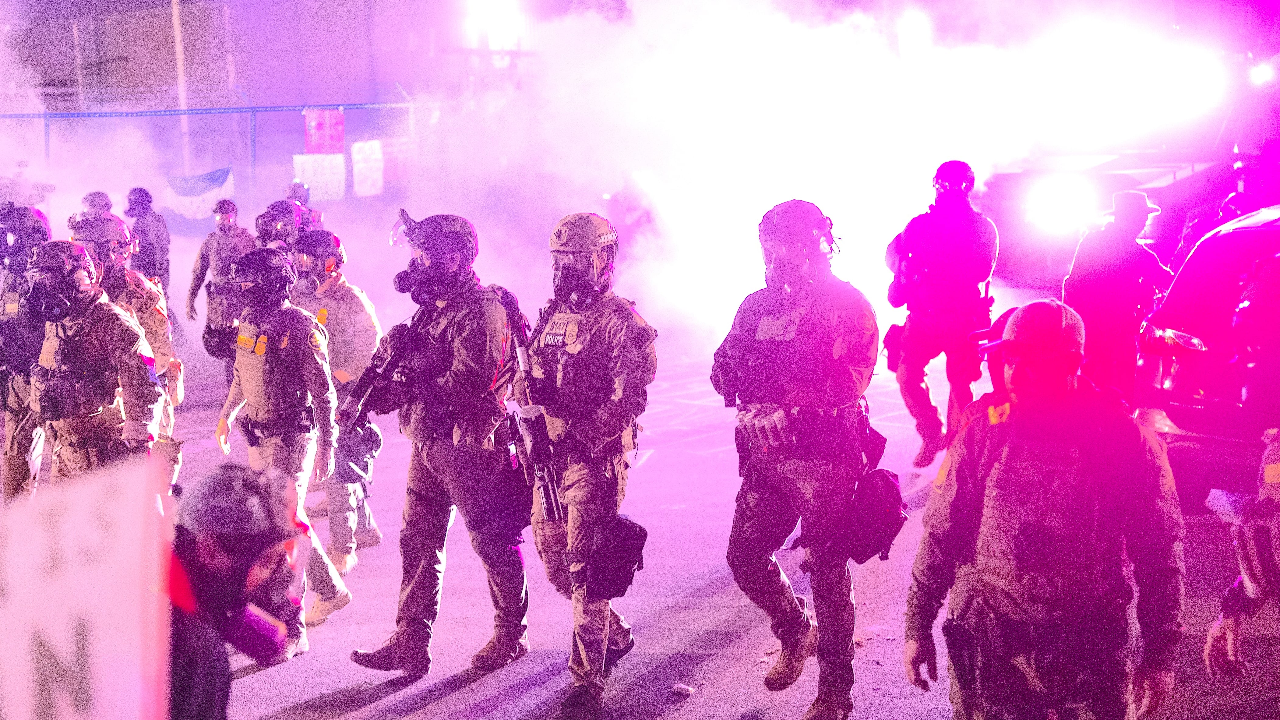 Federal law enforcement agents clash with demonstrators protesting outside of an immigrant processing center in Chicago. / Scott Olson/Getty Images