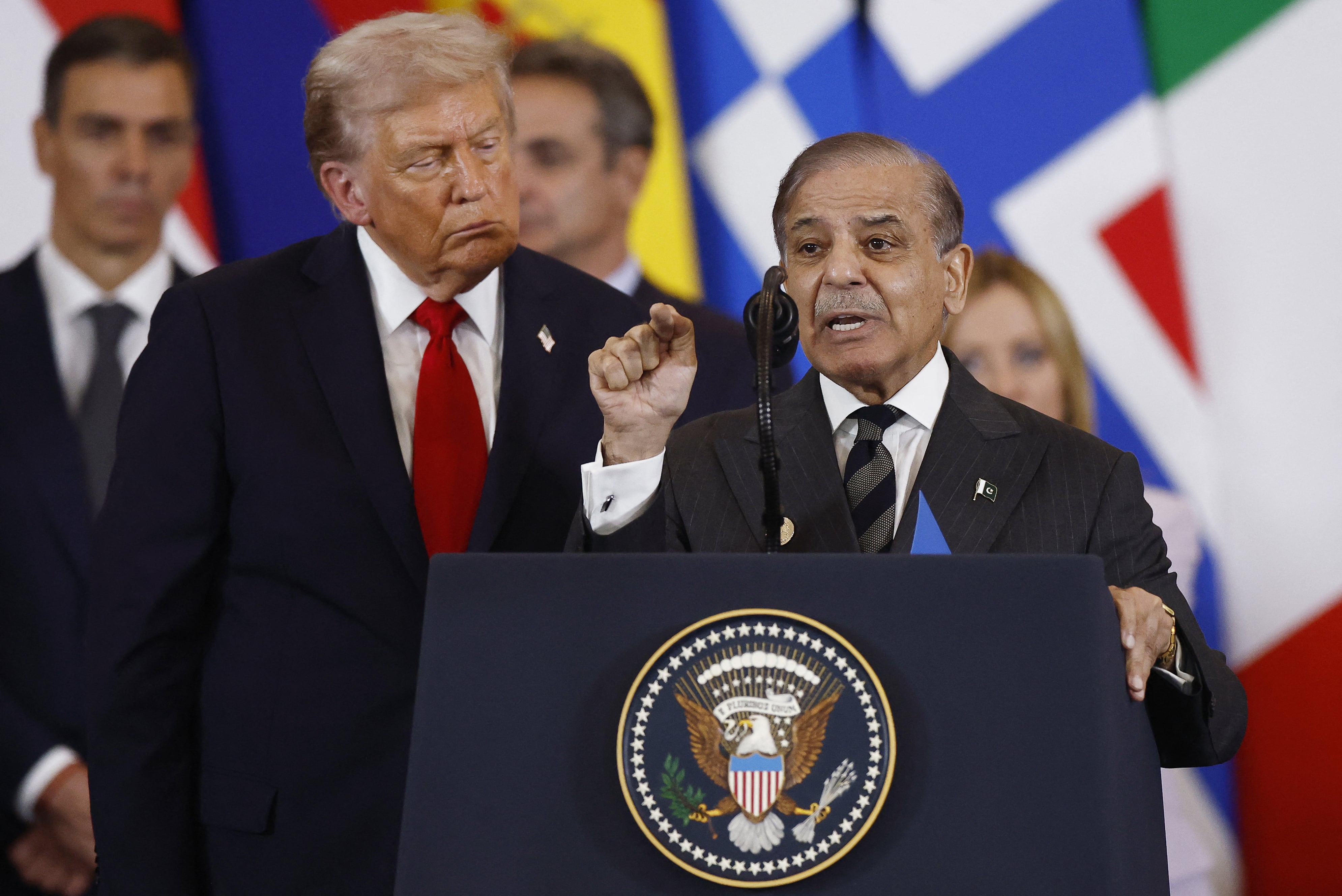 Trump, seen listening to Pakistan’s Prime Minister Shehbaz Sharif during the Gaza summit in Sharm el-Sheikh on Monday, claimed to have stopped a war between Pakistan and Iran. / Yoan Valat/Pool/AFP via Getty Images