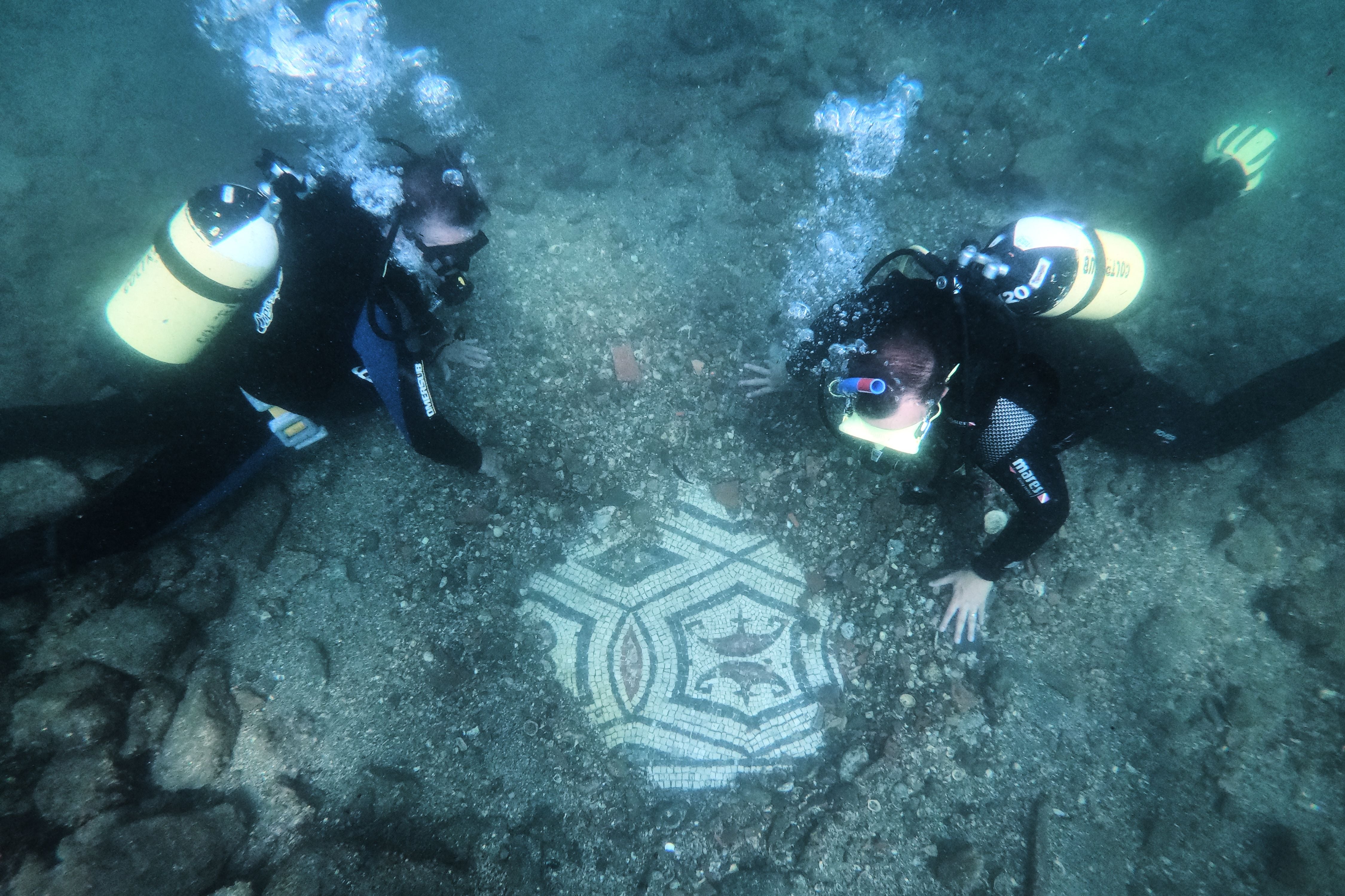 Recreational divers explore the ruins of domed bathhouses built for emperors at Baiae at the Campi Flegrei Archaeological Park. / Andreas Solaro/AFP via Getty Images