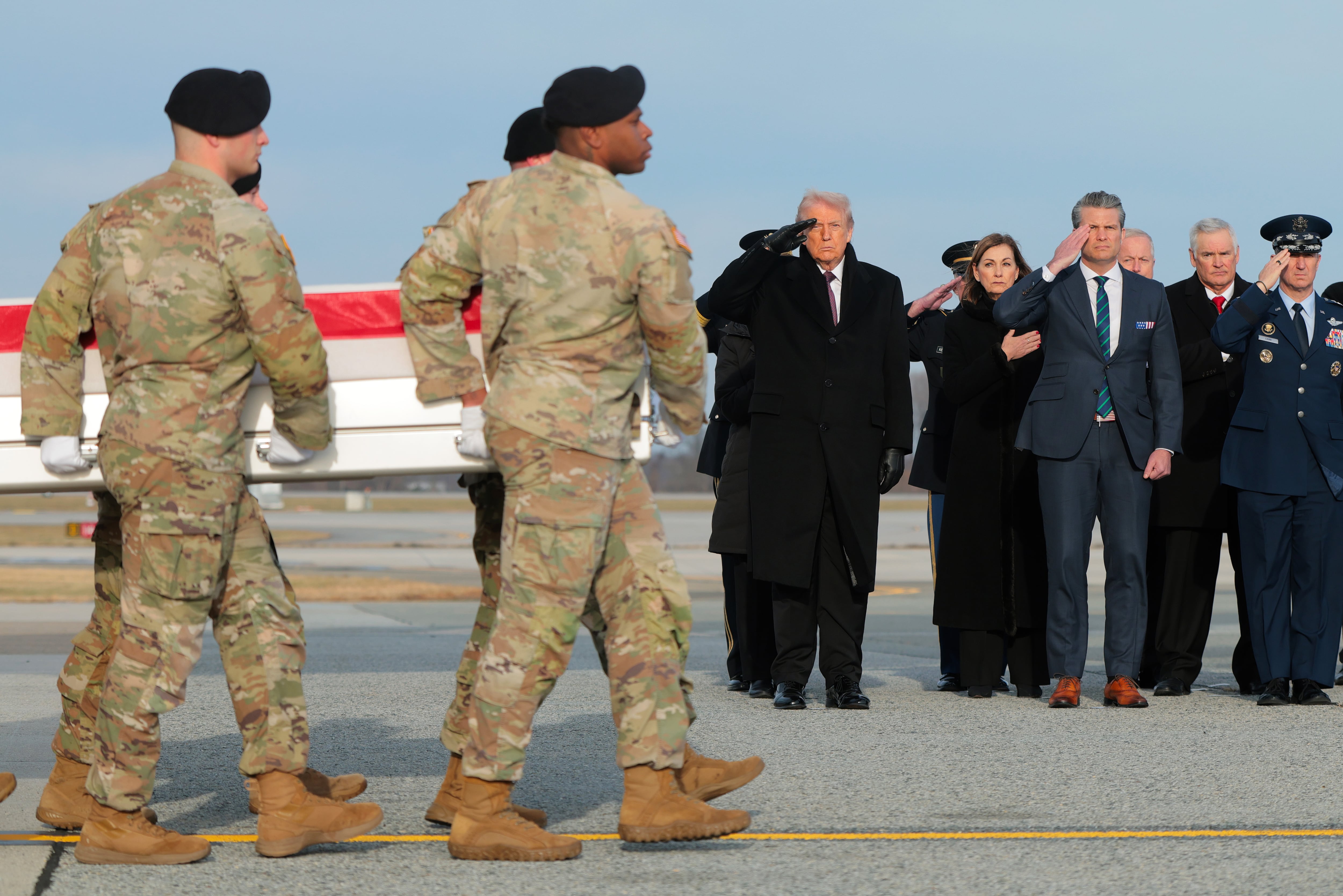 President Donald Trump and U.S. Secretary of War Pete Hegseth salute as a U.S. Army carry team moves a flagged-draped transfer case containing the remains of Iowa National Guardsman Sgt. Edgar Brian Torres-Tovar at Dover Air Force Base on December 17, 2025 in Dover, Delaware. / Anna Moneymaker / Getty Images